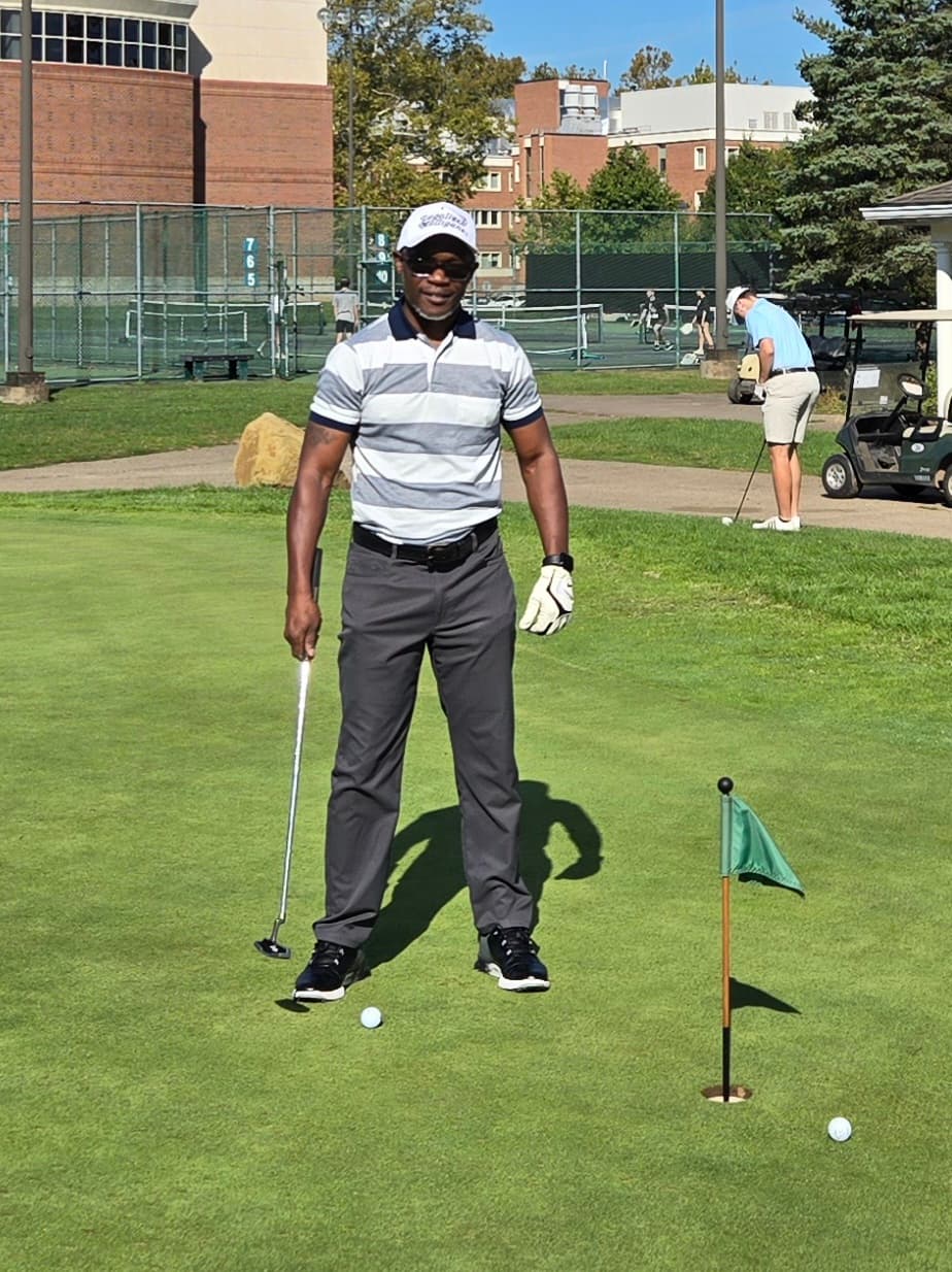 Patrick Mose standing on a putting green with a golf club
