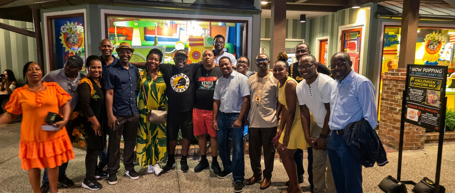 Patrick Mose with a diverse group of attendees at a community and cultural gathering.
