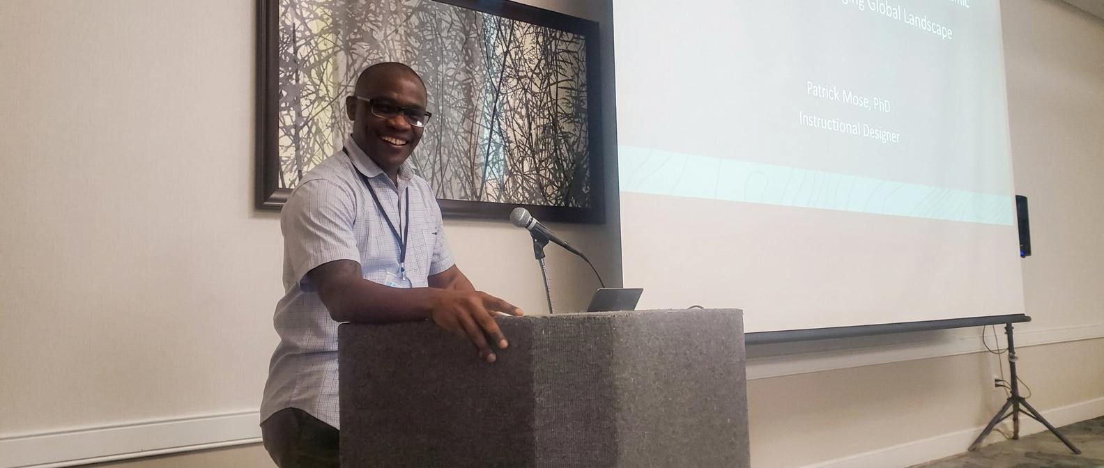 Patrick Mose speaking at a professional conference presentation from a podium